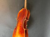 an old violin hanging on the wall in a room