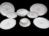 a lot of white plates and bowls on a black table
