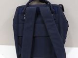 the back of a blue backpack sitting on top of a white table