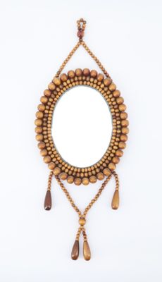 wooden beaded mirror with tassels and tassels hanging from it
