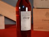 a bottle of wine sitting on a table next to a box