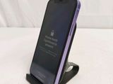 an iphone is sitting on top of a stand on a bed