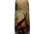 a glass vase with a painting on it on a white surface