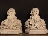 pair of white marble statues of a woman and a child