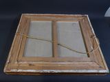 a picture of an old window with a rope on it