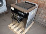 a machine that is sitting on a pallet in front of a washing machine
