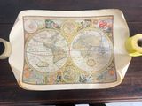 an old map on the table with a cup of coffee