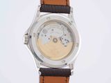 a close up of a watch on a white surface with a white background