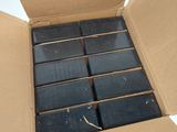 a cardboard box that has a bunch of black soap bars in it