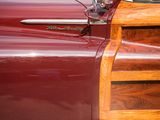 a close up of a red car with a wooden door
