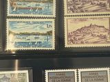 many different stamps on display in a display case