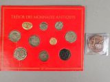 a close up of a red book with a bunch of coins on it