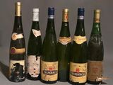 several bottles of wine are lined up in a row on a table