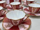 several cups and saucers are lined up on a table