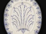 a blue and white plate with a design on it