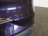 a purple car that is parked in a showroom