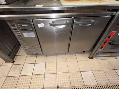 a kitchen with a stainless steel counter top and two ovens