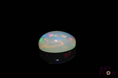 an image of a white fire opal in the dark