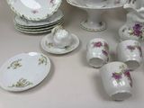 a lot of plates and cups and saucers on the table