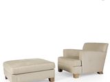 a white chair and ottoman sitting next to each other on a white surface