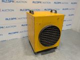 an image of a yellow heater sitting on top of a cement floor