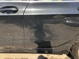 a shadow of a person standing in front of a car