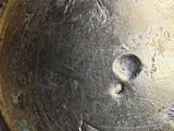 a close up of a metal object with a hole in it