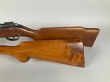 a wooden rifle with a black muzzle and a wooden barrel