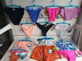 a lot of underwear hanging on a wall in a store