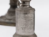 a silver vase that is sitting on a table