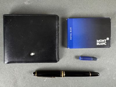 a black wallet, pen, and a blue notebook on a table