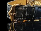 a close up of a watch on a black surface