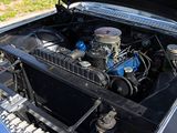 a blue car with an engine in the trunk of it