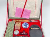 a red case with various items in it on a white surface