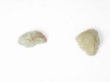 three pieces of carved ivory on a white surface