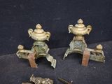 three pieces of antique brass on a black surface