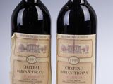 two bottles of wine sitting next to each other on top of a table