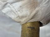 a close up of a umbrella with a white cover on it