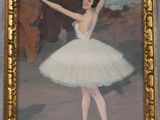 painting of a ballerina in a white tutu in a gold frame