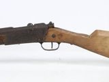an old rifle with a wooden handle on a white surface
