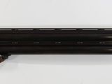 a shotgun with a brown leather case and a brown strap