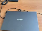 a laptop on a desk with a telephone on the side