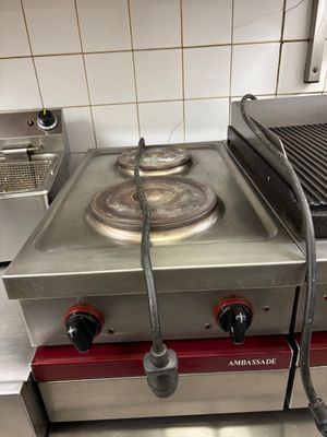 a gas stove with two burners on it in a kitchen