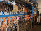 many chains and chains hanging on a rack in a room