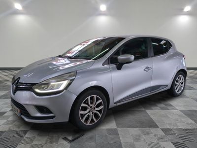 a silver car parked on a checkered floor in a garage