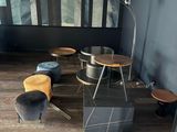a room with a table, chairs, and a picture on the wall