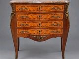 an antique chest of drawers with marble top