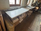 an image of a room with a table and a radiator in it