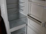 an empty refrigerator with its door open in a kitchen
