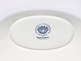 a white plate with a blue castle emblem on it